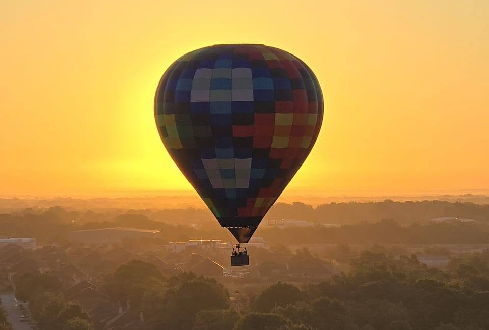 Rohr Balloons hot air balloon in flight at sunrise over North Texas