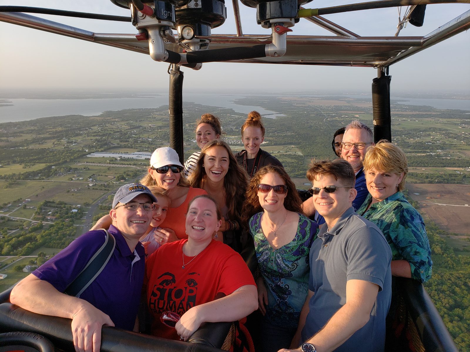 A full basket of passengers aloft over the green North Texas countryside