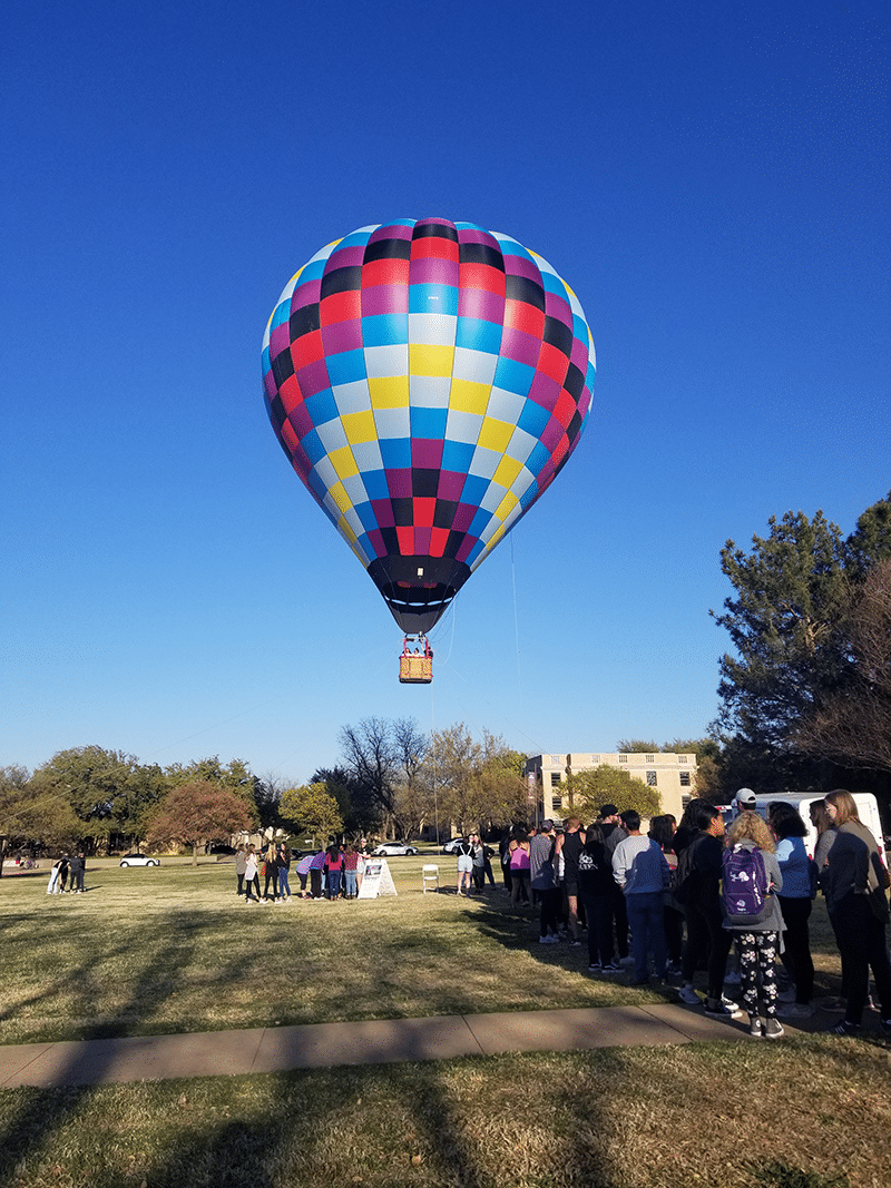 Excited guests waiting for a tethered hot air balloon ride